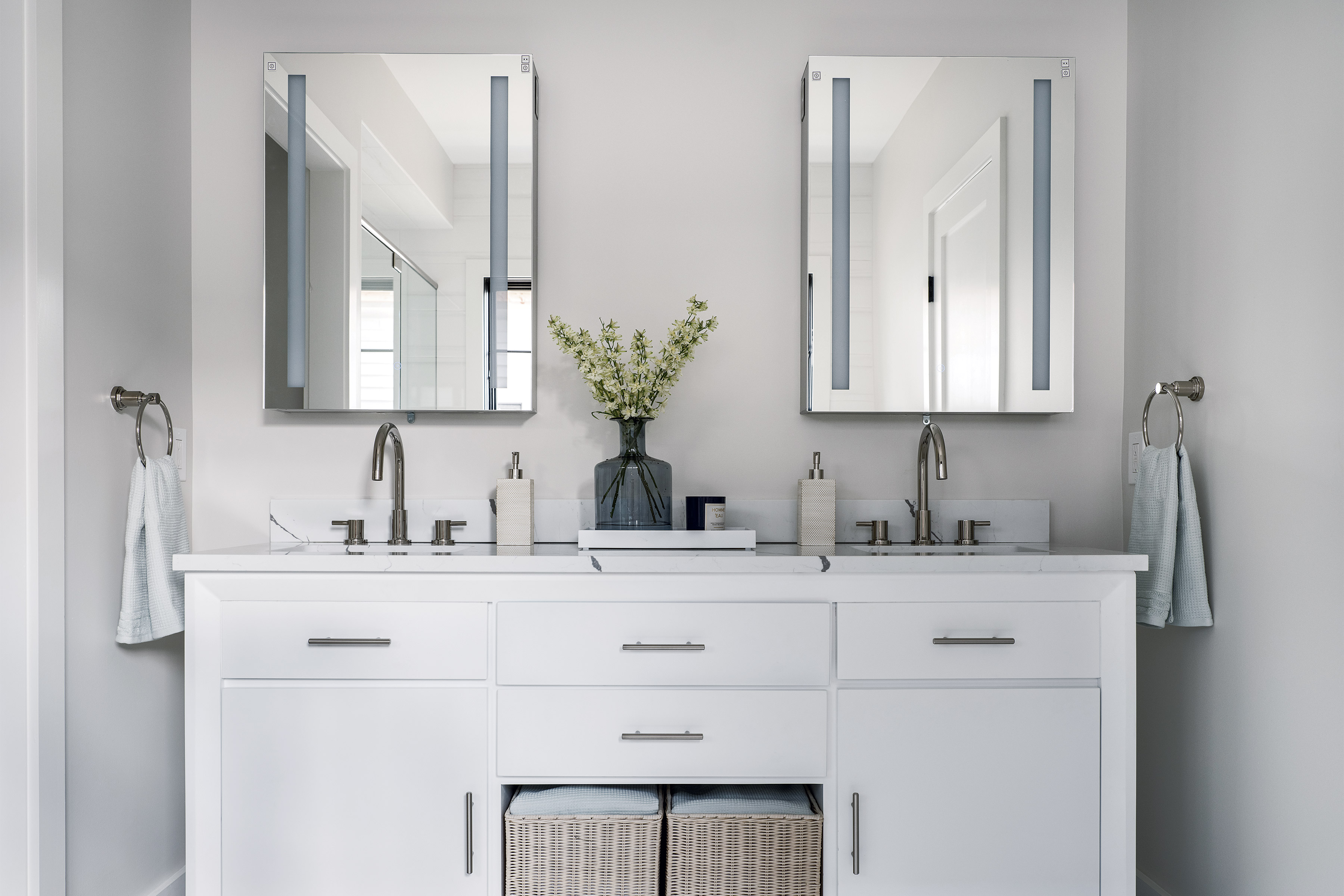A light gray bathroom with a double vanity.